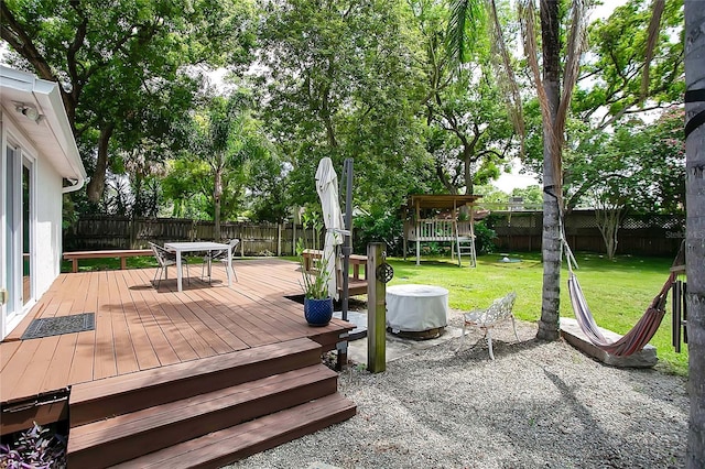 deck with a yard and a playground