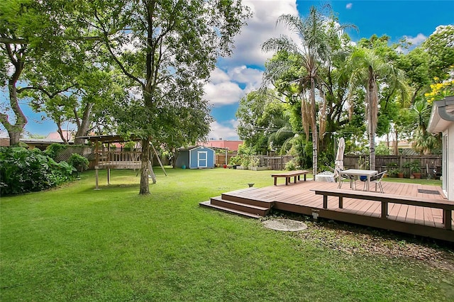 view of yard featuring a shed and a wooden deck