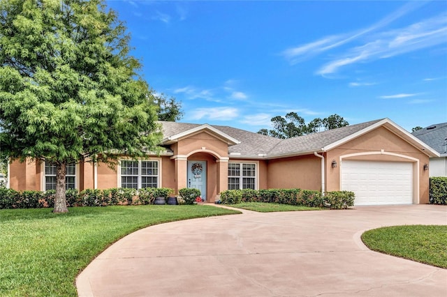 ranch-style home featuring a garage and a front lawn