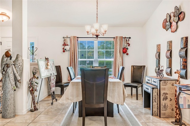 dining area with light tile patterned floors and an inviting chandelier