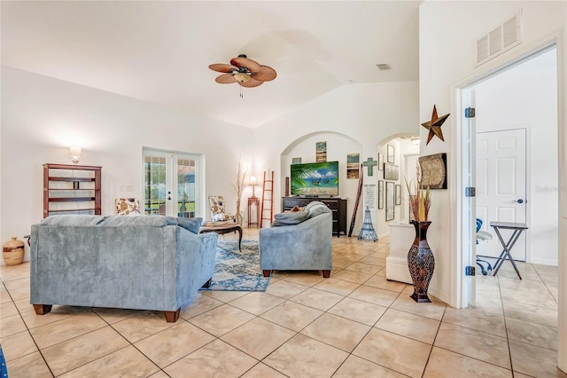 tiled living room featuring french doors, vaulted ceiling, and ceiling fan