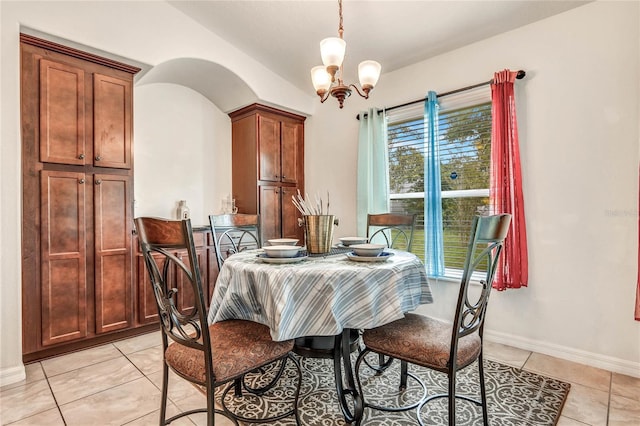 dining room featuring light tile patterned floors and a chandelier