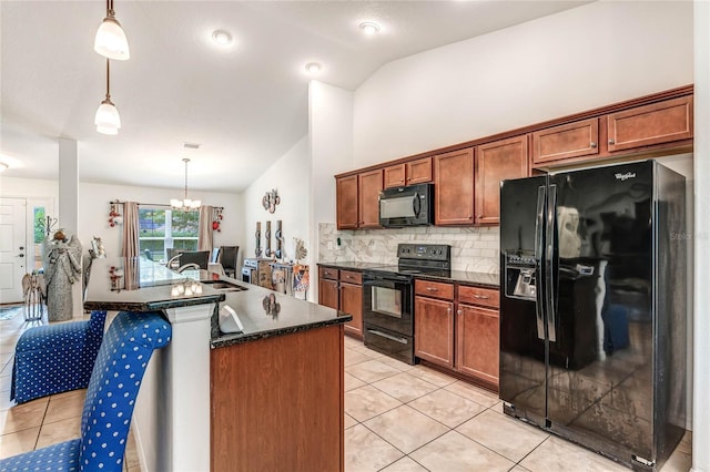 kitchen featuring pendant lighting, lofted ceiling, black appliances, tasteful backsplash, and a chandelier