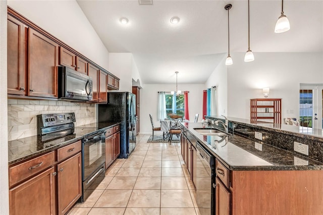 kitchen featuring tasteful backsplash, hanging light fixtures, black appliances, and sink