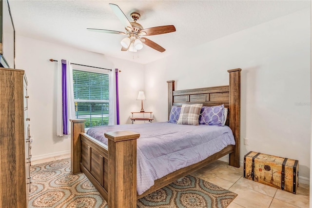 tiled bedroom with a textured ceiling and ceiling fan