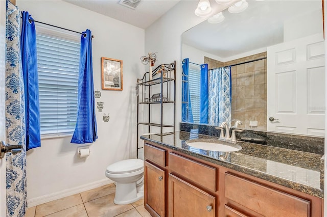 bathroom featuring toilet, vanity, tile patterned floors, and walk in shower