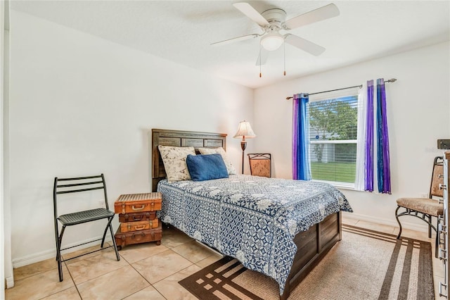 bedroom with ceiling fan and light tile patterned floors