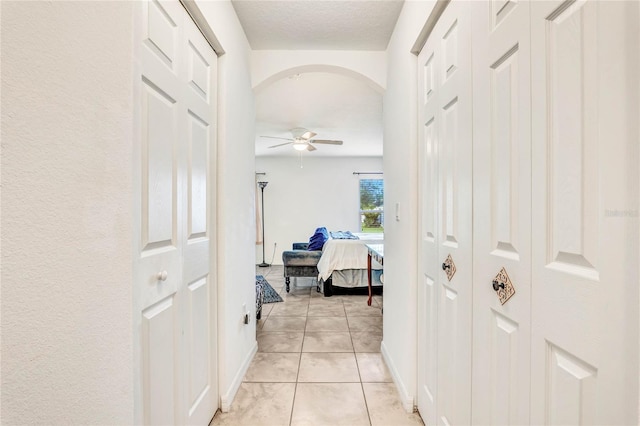 corridor with light tile patterned flooring