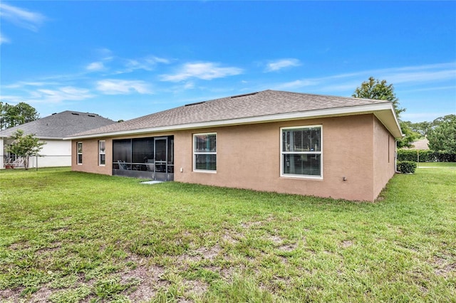 rear view of property with a yard