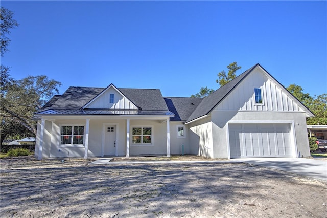 modern farmhouse with a porch and a garage