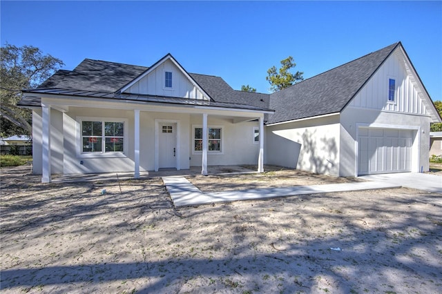 modern inspired farmhouse with covered porch and a garage