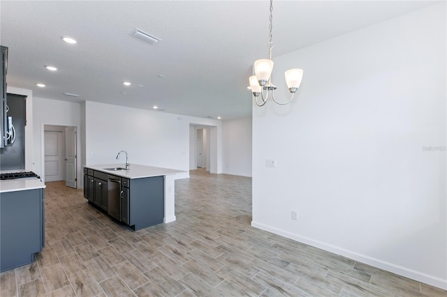 kitchen with sink, stainless steel dishwasher, pendant lighting, a center island with sink, and light wood-type flooring