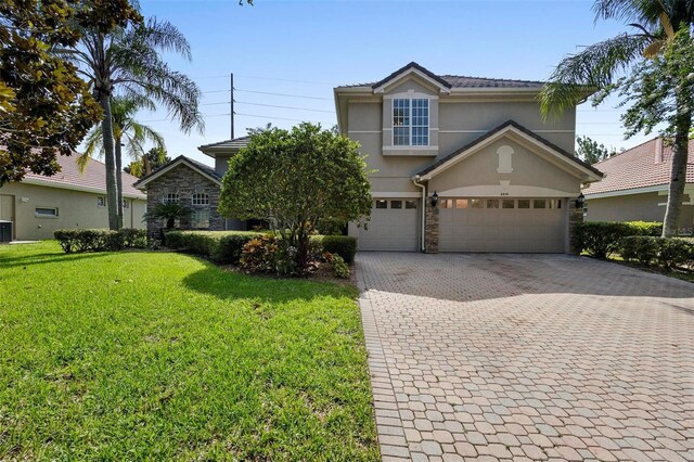 front of property with a garage and a front lawn