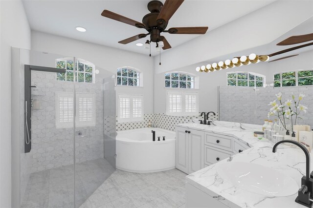 bathroom with vanity, a wealth of natural light, separate shower and tub, and ceiling fan