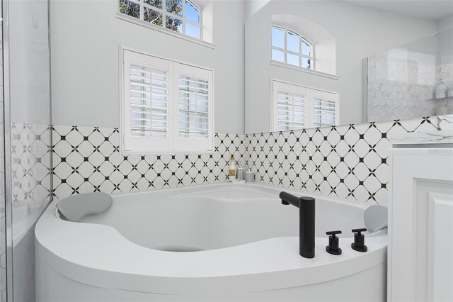 bathroom with a tub to relax in