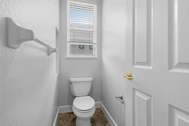 bathroom featuring tile patterned flooring and toilet