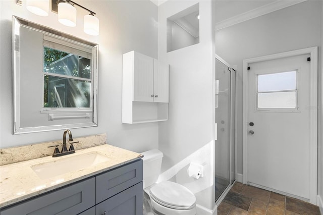 bathroom featuring crown molding, vanity, toilet, and an enclosed shower