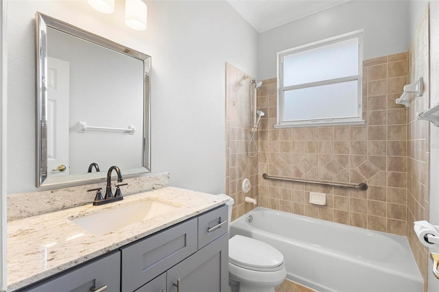 full bathroom featuring vanity, toilet, and tiled shower / bath combo