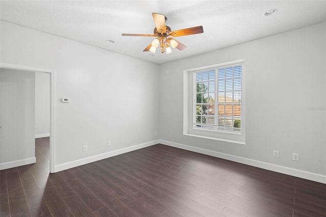 empty room featuring dark wood-type flooring and ceiling fan