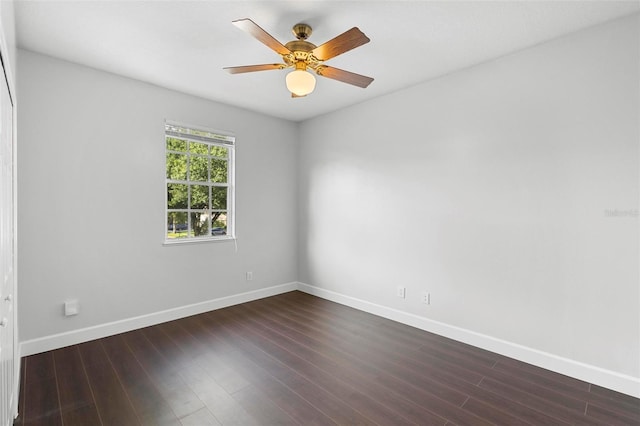 spare room with ceiling fan and dark hardwood / wood-style flooring