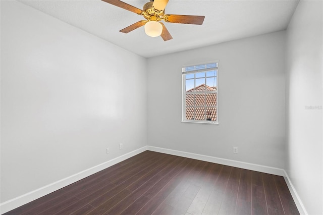 spare room featuring ceiling fan and dark hardwood / wood-style floors