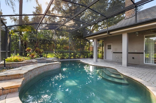 view of swimming pool featuring a lanai and a patio