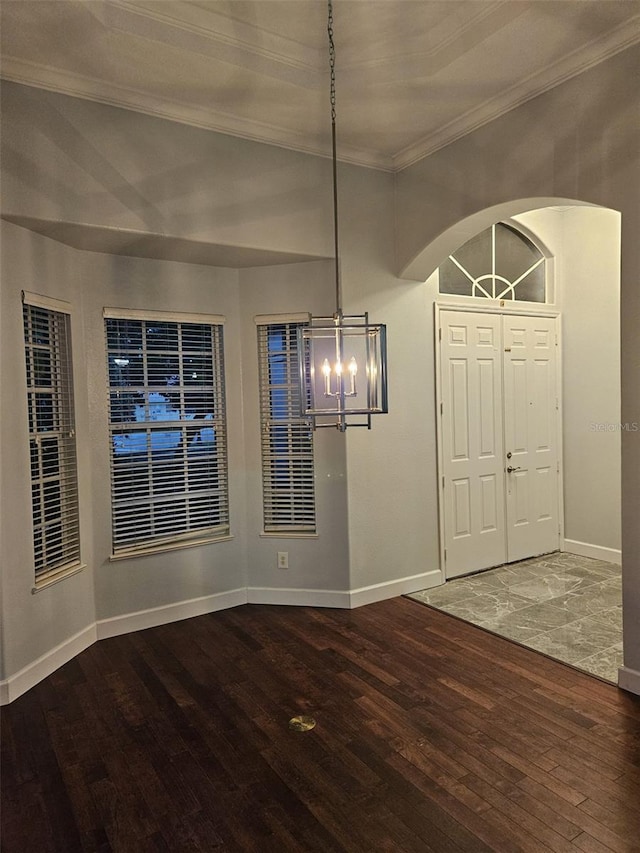 interior space with hardwood / wood-style floors, a chandelier, and crown molding