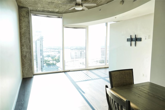 interior space with expansive windows, plenty of natural light, and hardwood / wood-style floors