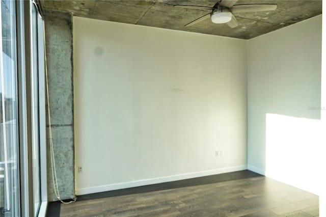 unfurnished room featuring dark wood-type flooring and ceiling fan