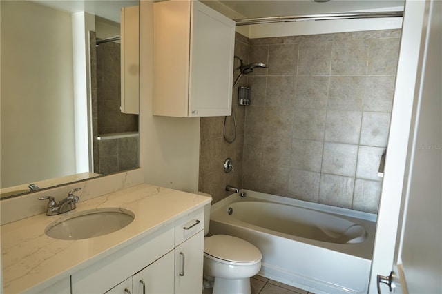 full bathroom featuring vanity, tiled shower / bath combo, tile patterned floors, and toilet