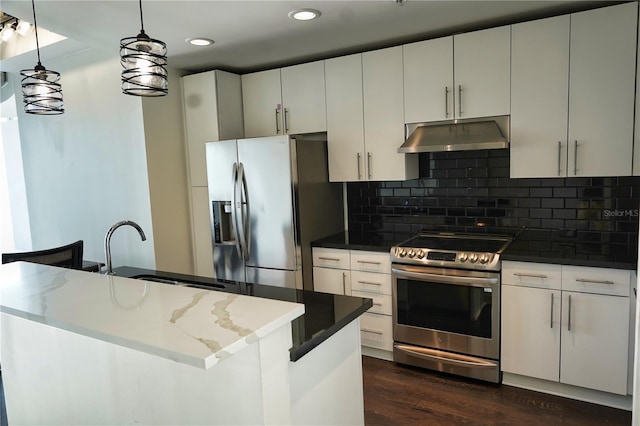 kitchen featuring appliances with stainless steel finishes, decorative backsplash, dark hardwood / wood-style floors, hanging light fixtures, and white cabinets