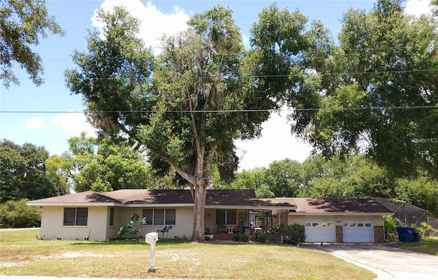 ranch-style house featuring a porch, a garage, and a front lawn