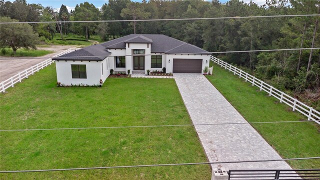 view of front facade with a garage and a front lawn