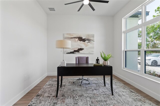 office area with ceiling fan, hardwood / wood-style flooring, and a wealth of natural light