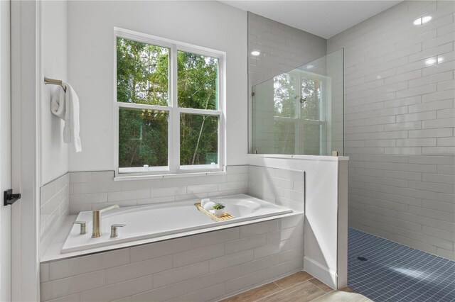 bathroom featuring independent shower and bath and tile patterned floors