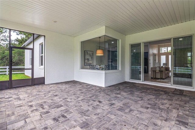 unfurnished sunroom featuring plenty of natural light