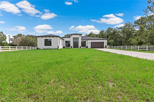 view of front facade with a garage and a front lawn