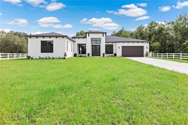 view of front of property with a garage and a front lawn