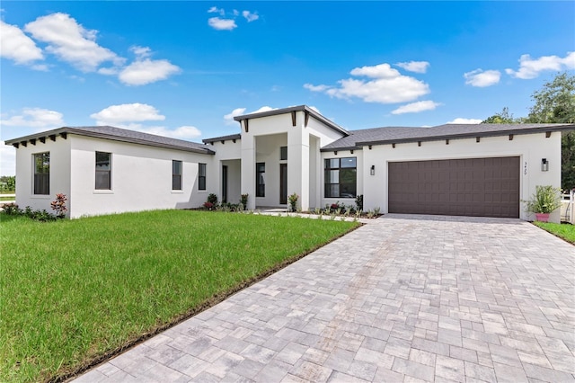 contemporary house with a garage and a front lawn