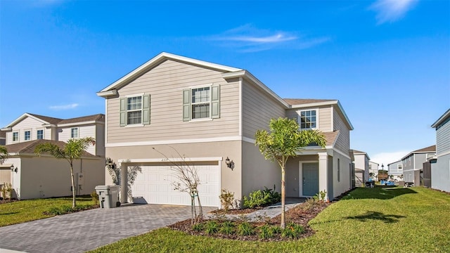 view of front of house with a front yard and a garage