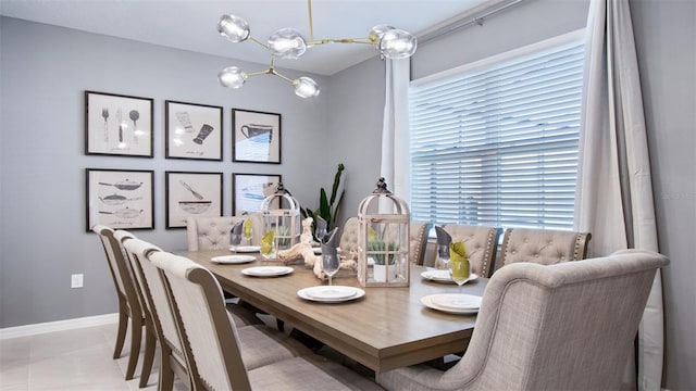 tiled dining area featuring plenty of natural light and a notable chandelier