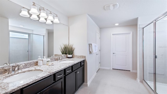 bathroom with an enclosed shower and vanity