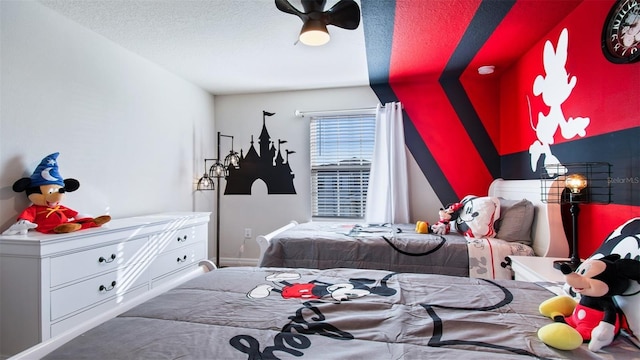 bedroom with a textured ceiling and ceiling fan