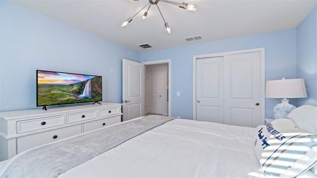 bedroom featuring a closet and a notable chandelier