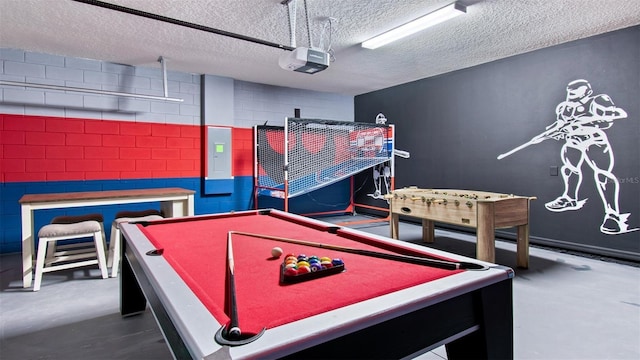 playroom featuring electric panel, a textured ceiling, pool table, and concrete flooring