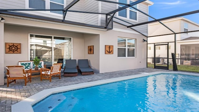 view of pool featuring a lanai and a patio area