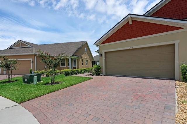 view of front of home featuring a front yard and a garage