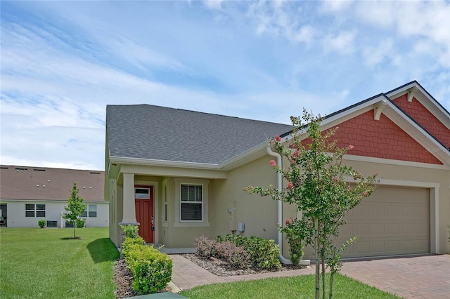 view of front of house with a garage and a front yard