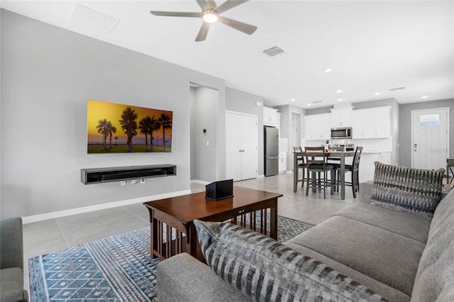 tiled living room featuring ceiling fan