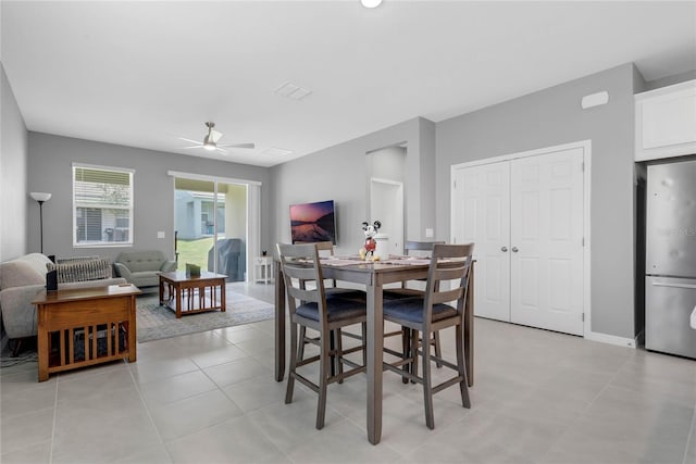 dining room featuring ceiling fan and light tile patterned flooring